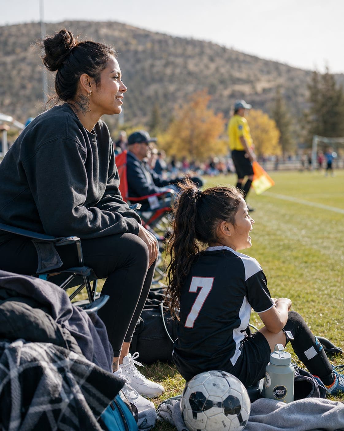 A parent watching a child's soccer game in Central Oregon